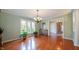 Bright dining room with hardwood floors, plants, and a large window offering a picturesque view at 7554 Silverpine Ct, Indianapolis, IN 46250