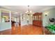 Dining room area featuring an antique hutch, hardwood floors, and elegant chandelier at 7554 Silverpine Ct, Indianapolis, IN 46250