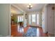 Welcoming foyer with hardwood floors, decorative rug, and a view into the light-filled living spaces at 7554 Silverpine Ct, Indianapolis, IN 46250