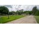 Expansive front yard and driveway lead to a charming home surrounded by mature trees and landscaping at 7554 Silverpine Ct, Indianapolis, IN 46250