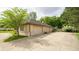Spacious garage with multiple bays and a large driveway, surrounded by lush greenery at 7554 Silverpine Ct, Indianapolis, IN 46250