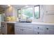 White kitchen with stainless steel dishwasher, a large sink and white cabinets at 7554 Silverpine Ct, Indianapolis, IN 46250