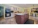 Full kitchen with center island featuring a full complement of appliances and barstool seating at 7554 Silverpine Ct, Indianapolis, IN 46250