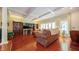 Cozy living room featuring hardwood floors, coffered ceilings, and comfortable seating arrangements at 7554 Silverpine Ct, Indianapolis, IN 46250