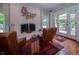 Cozy living room features a painted fireplace with decorative sconce and french doors to outdoor seating at 7554 Silverpine Ct, Indianapolis, IN 46250