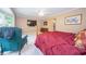 Sunlit bedroom with a large window, comfortable seating, and modern amenities, including a wall-mounted television at 7554 Silverpine Ct, Indianapolis, IN 46250