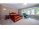 Serene bedroom with bay window, plush carpeting, a four-poster bed, and a comfortable armchair at 7554 Silverpine Ct, Indianapolis, IN 46250