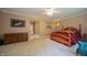 Spacious bedroom showcasing a traditional wooden bed frame, soft carpeting, and calming neutral color scheme at 7554 Silverpine Ct, Indianapolis, IN 46250