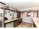 Basement bar area with wood-style flooring, sink, shelving, and appliances at 7733 Chestnut Eagle Ct, Zionsville, IN 46077