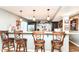 Basement bar includes counter seating, modern pendants, and drink storage at 7733 Chestnut Eagle Ct, Zionsville, IN 46077