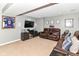 Finished basement features a media area with a large screen TV, speakers, and comfortable seating at 7733 Chestnut Eagle Ct, Zionsville, IN 46077