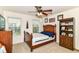 Cozy bedroom with a ceiling fan, a window, and a built-in bookshelf at 7733 Chestnut Eagle Ct, Zionsville, IN 46077