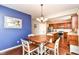 Open dining area with stainless steel appliances, cherry cabinets, and hardwood floors at 7733 Chestnut Eagle Ct, Zionsville, IN 46077