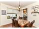 Traditional dining room featuring a marble table, chandelier lighting, and hardwood floors at 7733 Chestnut Eagle Ct, Zionsville, IN 46077