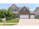 Charming two-story home with a manicured lawn, brick accents, and a three car attached garage at 7733 Chestnut Eagle Ct, Zionsville, IN 46077