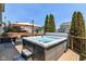 Backyard Deck area with a modern hot tub and outdoor seating with beautiful neighborhood views at 7733 Chestnut Eagle Ct, Zionsville, IN 46077