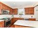 Charming kitchen with stainless steel appliances and island at 7733 Chestnut Eagle Ct, Zionsville, IN 46077
