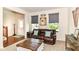 Cozy living room with a leather sofa, area rug, and rustic wood coffee table at 7733 Chestnut Eagle Ct, Zionsville, IN 46077