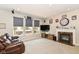 Bright living room with fireplace, TV, and natural light at 7733 Chestnut Eagle Ct, Zionsville, IN 46077