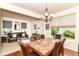 Open-concept living room featuring a dining area, hardwood floors, and comfortable leather furniture at 7733 Chestnut Eagle Ct, Zionsville, IN 46077