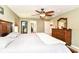Comfortable main bedroom featuring a ceiling fan, dresser and ensuite bathroom at 7733 Chestnut Eagle Ct, Zionsville, IN 46077