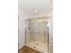 Bathroom shower with frameless glass doors and built-in shelves at 7733 Chestnut Eagle Ct, Zionsville, IN 46077