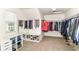 Spacious walk-in closet with window and shoe storage at 7733 Chestnut Eagle Ct, Zionsville, IN 46077