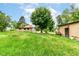 This backyard features a detached garage surrounded by greenery, offering a private and serene outdoor space at 7829 Rahke Rd, Indianapolis, IN 46217
