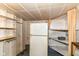 A basement area with shelves and a refrigerator at 7829 Rahke Rd, Indianapolis, IN 46217