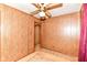 A bedroom featuring wood paneling, carpet and doorways at 7829 Rahke Rd, Indianapolis, IN 46217