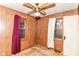 A bedroom with wood paneling, windows and carpet at 7829 Rahke Rd, Indianapolis, IN 46217