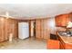 Retro kitchen featuring wood cabinets and linoleum floors, offering a vintage vibe with functional storage at 7829 Rahke Rd, Indianapolis, IN 46217