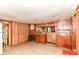 Retro kitchen featuring wood cabinets and linoleum floors, offering a vintage vibe with functional storage at 7829 Rahke Rd, Indianapolis, IN 46217