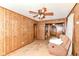 A living room featuring wood paneling, carpet and furniture at 7829 Rahke Rd, Indianapolis, IN 46217