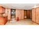 Spacious living area with wood paneling, providing a cozy and inviting atmosphere for relaxation at 7829 Rahke Rd, Indianapolis, IN 46217