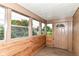 Enclosed sunroom with multiple windows and a door, providing a bright and airy space at 7829 Rahke Rd, Indianapolis, IN 46217