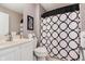 Modern bathroom with bold graphic patterned shower curtain and updated vanity at 8425 Codesa Way, Indianapolis, IN 46278
