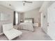 Serene bedroom with neutral tones, plush carpeting, and a comfortable chaise lounge at 8425 Codesa Way, Indianapolis, IN 46278