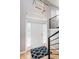 Bright foyer featuring a modern light fixture, staircase, and a patterned rug at 8425 Codesa Way, Indianapolis, IN 46278