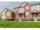 Charming brick townhouse with a well-manicured lawn and inviting front entrance at 8425 Codesa Way, Indianapolis, IN 46278