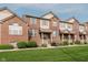 Charming brick townhouse with a well-manicured lawn and inviting front entrance at 8425 Codesa Way, Indianapolis, IN 46278