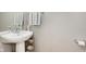 Neat half bathroom featuring a pedestal sink and a wall-mounted towel rack at 8425 Codesa Way, Indianapolis, IN 46278
