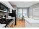 Bright kitchen boasts white cabinets, stainless steel appliances, herringbone backsplash, and sun-lit eating area at 8425 Codesa Way, Indianapolis, IN 46278