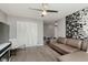 The living room includes a ceiling fan, laminate flooring, and a comfortable sectional sofa at 8425 Codesa Way, Indianapolis, IN 46278