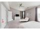 Spacious main bedroom with vaulted ceiling, ceiling fan, and relaxing chaise lounge seating area at 8425 Codesa Way, Indianapolis, IN 46278