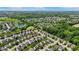 Areal view of a suburban community featuring tree-lined streets and a serene pond at 8447 Wanda Lake Dr, Camby, IN 46113