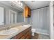 Bathroom with a double sink vanity, shower with curtain, and light gray walls at 8447 Wanda Lake Dr, Camby, IN 46113