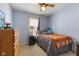 Cozy bedroom with a ceiling fan, a plushy on the bed, and a window letting in natural light at 8447 Wanda Lake Dr, Camby, IN 46113