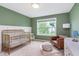 Charming Bedroom boasts neutral green walls, a cozy chair, a plush rug, and abundant natural light at 8556 N Deer Hill Dr, McCordsville, IN 46055
