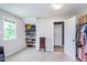 Bright bedroom features carpet floors, a window with natural light, and built-in shelving for stylish storage at 8556 N Deer Hill Dr, McCordsville, IN 46055